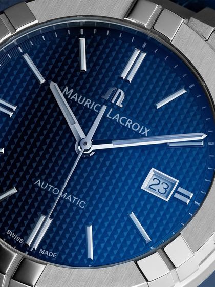 An extreme close-up of the Maurice Lacroix Aikon, focusing on the intricate "Clous de Paris" pattern on the dial. Capturing this texture requires very specific, angled lighting to create the shadows that give it depth.