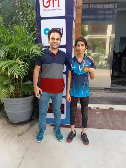 Our coach with player Kavya Bhat, who is holding her bronze medal from the UTT National Ranking Tournament in Telangana. This image shows the supportive environment we foster.