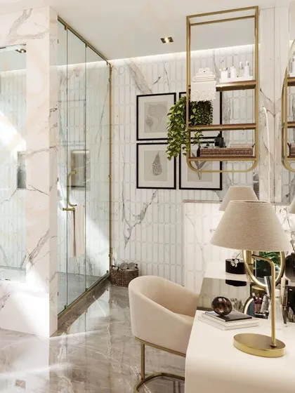 A close-up of the dressing table area, complete with a comfortable chair, a lighted mirror, and elegant gold-accented shelving.