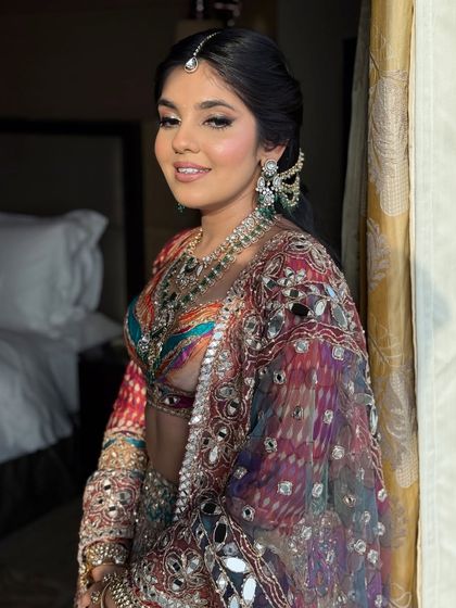 Another view of the garba night look, showing how the makeup enhances the bride's features and complements her vibrant outfit.