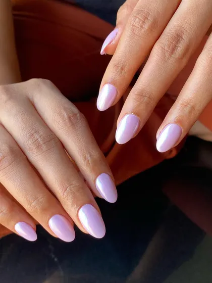 A gorgeous set of temporary nail extensions in a soft lavender color with a subtle chrome finish.