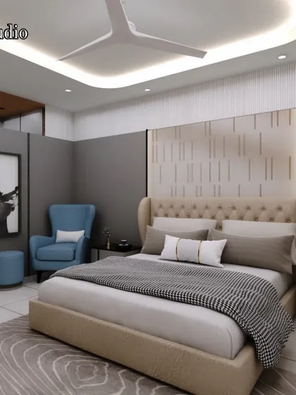 A modern bedroom design with a tufted headboard and a cozy reading corner with a comfortable armchair. The color palette of beige, grey, and blue creates a calm and balanced atmosphere.