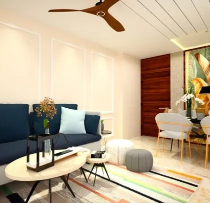 A look at a cozy living and dining area we designed for a 2BHK home. We used a deep blue sofa to add a pop of color against the neutral walls and a simple, elegant dining set that doesn't overwhelm the space.