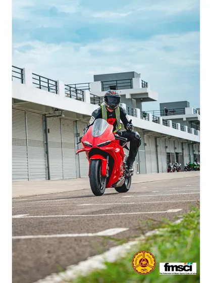 A rider on a bright red Ducati Panigale V2, ready for their session. The pit lane is always buzzing with excitement.