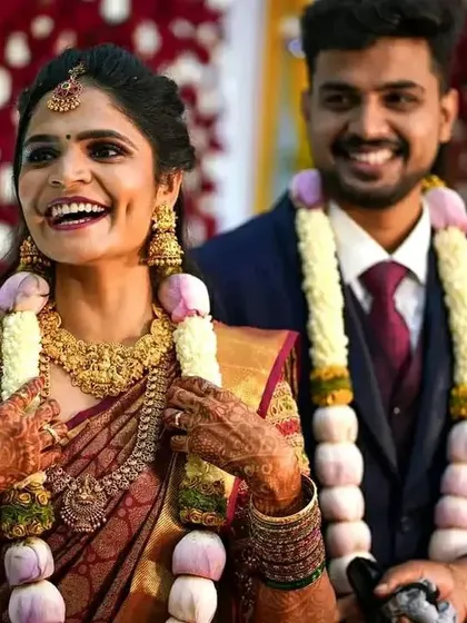 The best part of my job is seeing a bride's joyful smile. This candid moment captures the complete reception look, from the perfectly draped saree and traditional garlands to the radiant makeup that lasts all evening.