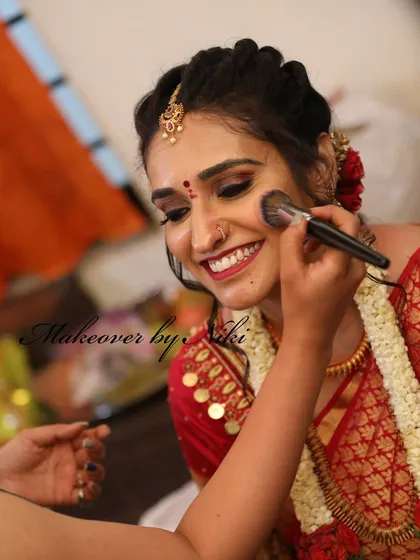 A smile during the process. I love seeing my brides happy and relaxed as their look comes together. Here, I'm applying blush to enhance Pooja's beautiful smile.