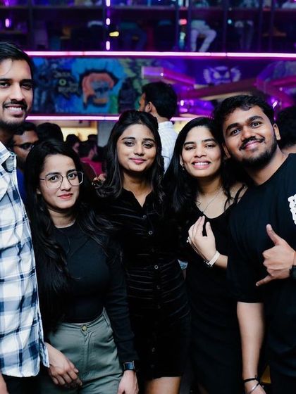 Friends posing for a photo amidst the party. BOHO's vibrant atmosphere makes for great memories and even better pictures.