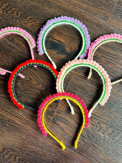 A collection of my uber-cute crochet hairbands laid out to show the different color options, from pretty pastels to bold and bright combinations.