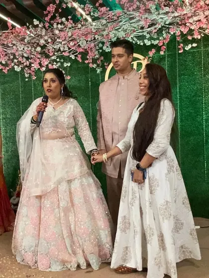 Holding hands with the bride on stage. I'm there to support my clients every step of the way.