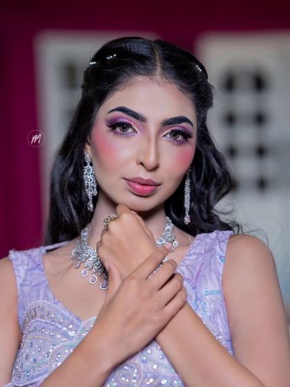 A close-up portrait that highlights the sharp, artistic eye makeup.