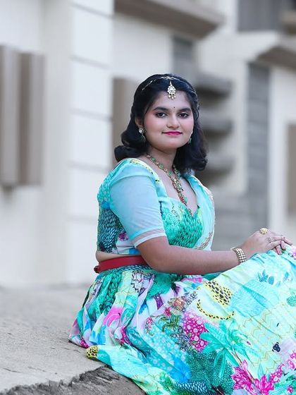My flora and fauna lehenga is perfect for celebrating youthful grace. The vibrant, printed skirt is paired with a textured green blouse and a light blue net dupatta, creating a fresh and lively look for my teenage client Honisha.