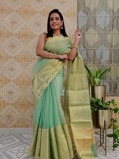 This sea green tissue saree with a golden border is so elegant and classy. It's a lightweight saree that gives a very rich look.