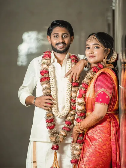 A happy couple posing for a photo on their wedding day. It's a joy to be a part of these special moments.