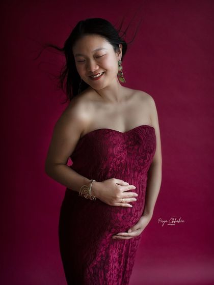 A soft and gentle smile. This close-up portrait captures the serene happiness and inner glow of an expecting mother.