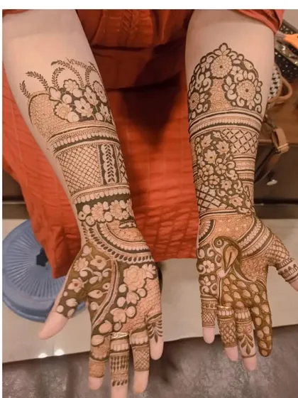 This design shows how different patterns on each hand can create a unique, coordinated look, with one hand featuring a peacock and the other focusing on floral work.