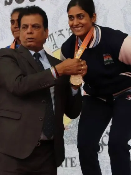 Awarding a medal to Ms. Bhuvaneshwari Jadhav at a national event. Her journey from national champion to Asian medalist is a path we create for our dedicated athletes.