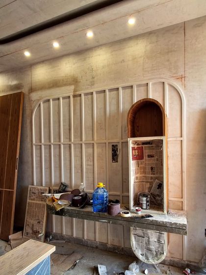 A TV panel unit under construction. This behind-the-scenes shot shows the wooden framework and arch details before the final finishes are applied.