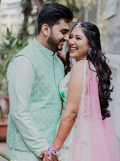 A happy, candid portrait of the couple during their Haldi festivities. Their genuine laughter and connection are the focus of this shot.