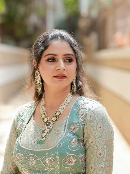 A close-up of our client in a pastel green brocade lehenga. The intricate silver embroidery on the blouse and the soft, elegant fabric make this a perfect choice for a Mehendi ceremony or daytime wedding.