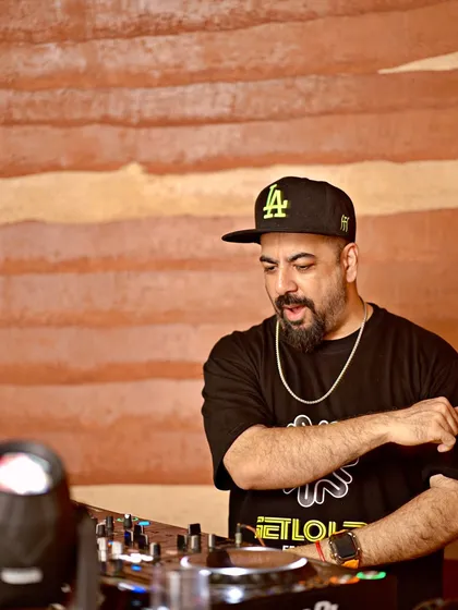 Focused on the mix at Lumara. I'm always locked in, making sure the music flows perfectly for the rooftop setting.