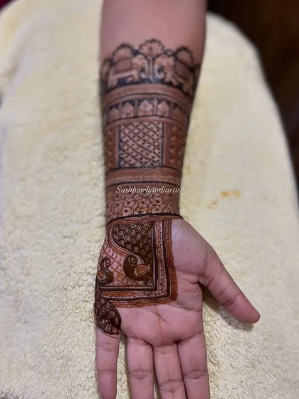 A closer look at the details. You can see the clean lines in the elephant motifs and the delicate shading in the peacock figures, all done with a steady hand.