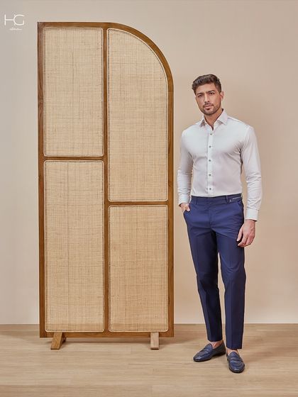 Tailored office wear in timeless tones. This classic white shirt is paired with perfectly fitted navy trousers for a look that is sharp, elegant, and always professional.