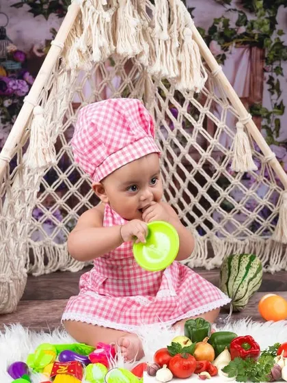 Our little chef surrounded by fresh vegetables and cooking tools. I provide a wide range of props to make every themed shoot feel authentic and fun.