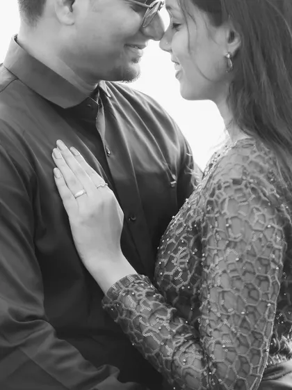 A black and white close-up that emphasizes emotion and connection, focusing on the gentle touch and loving expressions.