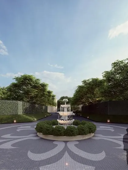 After passing through the main gate, guests are greeted by a wide, impressive driveway centered around a classic tiered fountain. This carefully planned approach builds anticipation and reinforces the palatial scale of the venue, surrounded by lush, mature trees.
