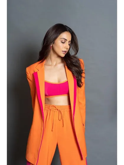 Power dressing but make it pop. I love playing with bold color combinations, like this orange and pink pantsuit from Antithesis for Rakul Preet. This look is confident, modern, and perfect for making a statement at a formal conclave or press event.