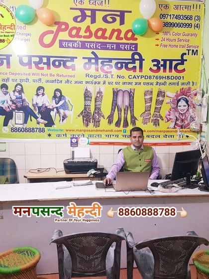 A photo of me, Rajkumar, at my desk in the Manpasand Mehndi office. I am always here to personally handle your bookings and ensure the best service.