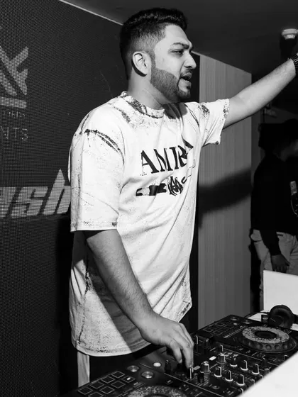 A candid black and white shot of me in action. Pointing to the sky, feeling the rhythm, and getting ready for the next big track.
