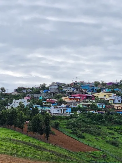 A colorful village nestled in the hills. These landscapes look like they're straight out of a childhood scenery painting.