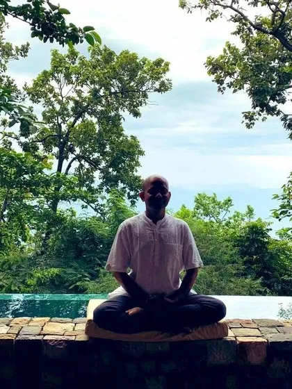 Here I am in the Himalayas, a place of immense peace. I find that meditating in nature, by the water, helps connect me to the stillness within. In my classes, I guide you to find this same sense of inner quiet, no matter where you are.