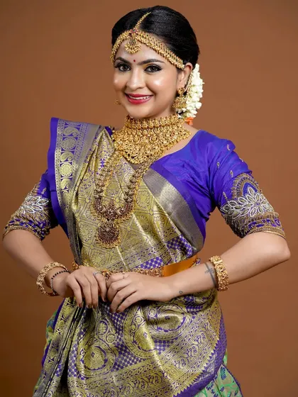 The complete look, showing how the jewellery enhances the richness of the saree.