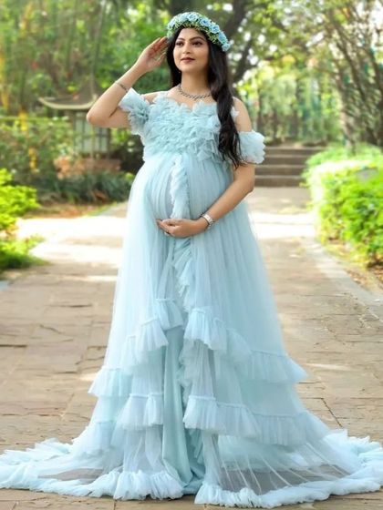 A beautiful solo portrait in our light blue ruffled gown, perfect for an outdoor garden or park setting. The floral headband completes the whimsical, fairy-like look.