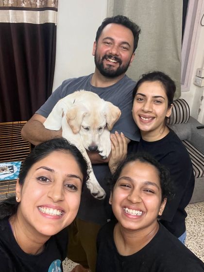 A happy moment with clients and team members after a successful training session with a new puppy. We build lasting relationships with the families we work with.