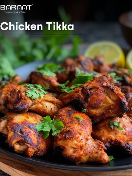 Garnished with fresh cilantro, these pieces of Chicken Tikka are perfectly charred and ready to be enjoyed with a squeeze of lemon.