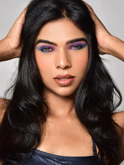 A close-up beauty shot showcasing a vibrant and creative eye makeup look. I used a dual-tone blend of purple and blue eyeshadow with a sharp wing, paired with a nude lip to make the eyes the central focus. This is ideal for bold editorial concepts.