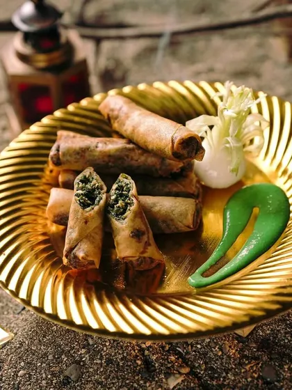 Another view of the Spinach Chicken Cigars, elegantly plated on a golden dish. They are a light yet satisfying starter for any occasion.