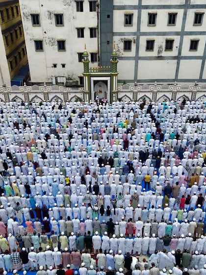 A moment of unified prayer during Eid in Kolkata. The drone's perspective highlights the perfect symmetry and devotion of the gathering, with rows of people filling the courtyard.