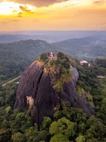 An aerial view of an ancient Shiva temple perched atop a massive rock monolith in South Canara. This shot combines the thrill of drone photography with the deep-rooted history of our land, telling a story of faith and nature intertwined. The sunset colours add a layer of divine glow to the scene.