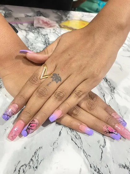 This set is all about playful and detailed art. I created a soft pink and purple ombré base on long square nails, then added hand-painted butterfly wing details and glitter accents for a whimsical, eye-catching finish.