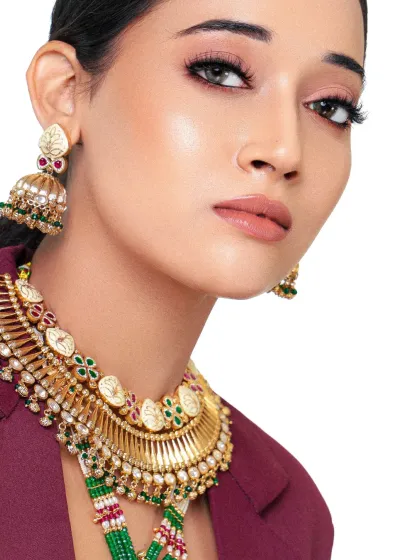 Draped in culture, tailored for power. This modern take on ethnic wear pairs a heavy traditional necklace with a sharp blazer, creating a unique fusion look.