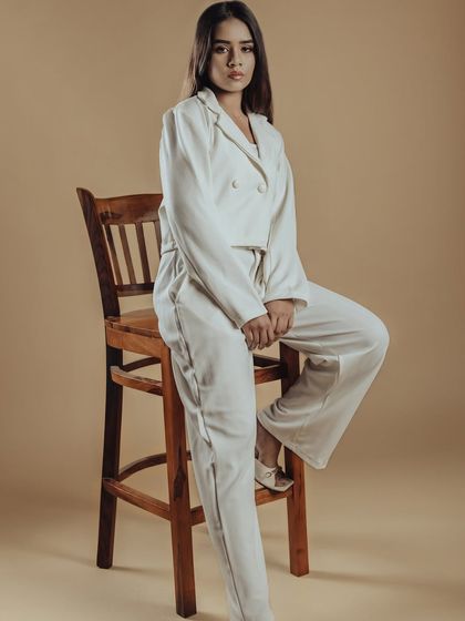 A full-length shot from the 'Allure' editorial series. The makeup is designed to complement the monochromatic styling, proving that sometimes less is more.