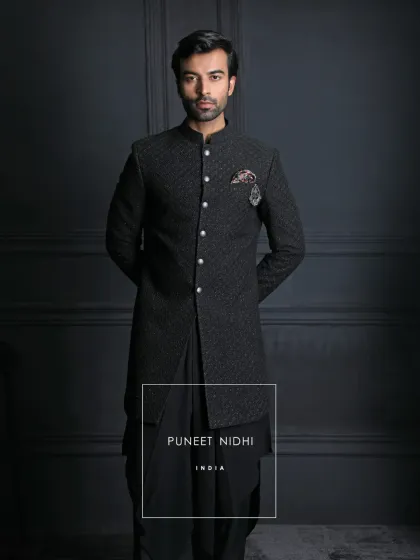 Every detail is a chapter of heritage. The textured black achkan, the gleam of silver buttons, and the fluid drape of the kurta embody the timeless grandeur of Indian royalty.