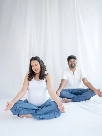 Let's have fun. A maternity session should feel like you. Here, we captured the playful, happy energy of this couple with a minimalist, bright white setup that lets their personalities shine through.
