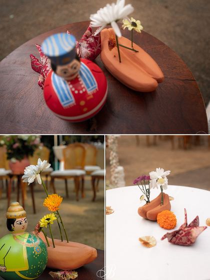 More details of the terracotta centerpieces, paired with colorful Channapatna dolls. This combination of earthy terracotta and vibrant wooden crafts creates a beautiful, rustic-chic aesthetic.