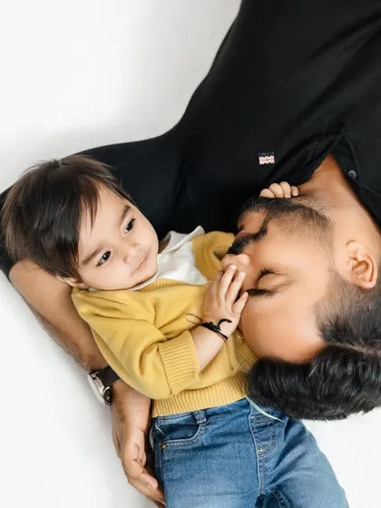 A sweet and playful moment between a father and his son, captured from an interesting angle in our studio.