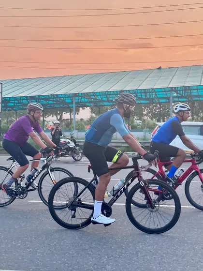 A great action shot of the group riding against a sunset-hued sky.